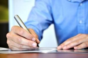 Employee writing on a paper